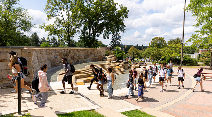 students walking to class in front of fountain