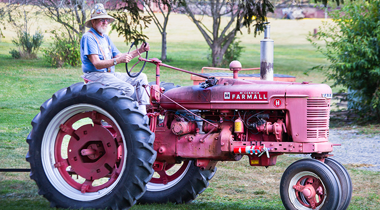 Man on a Farmall tractor