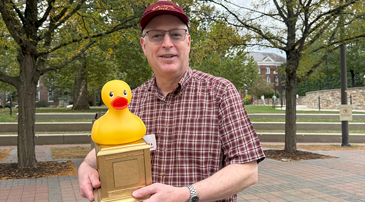 Person holding duck trophy