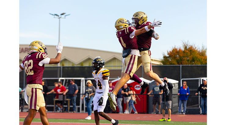 two football players celebrating on the field