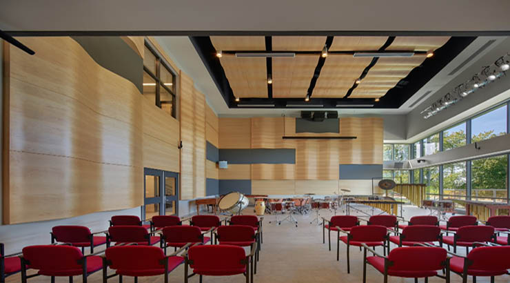 room with chairs and a drum kit in the front