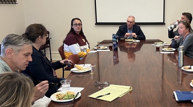 people eating food around a table