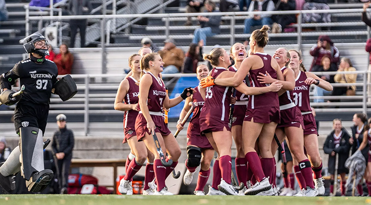 Field hockey players celebrating on field