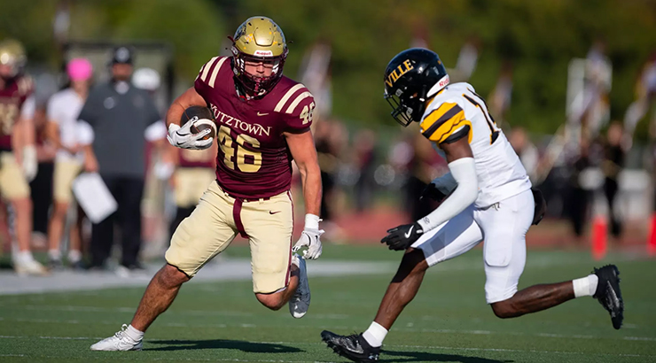 Football player running with football