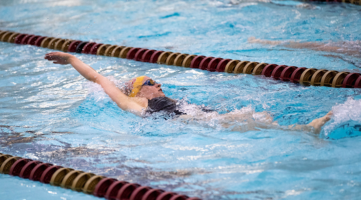 Photo of Gracie McKee swimming the backstroke.