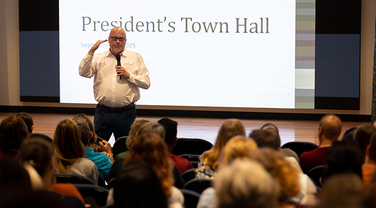 Cavalier speaking in front of room