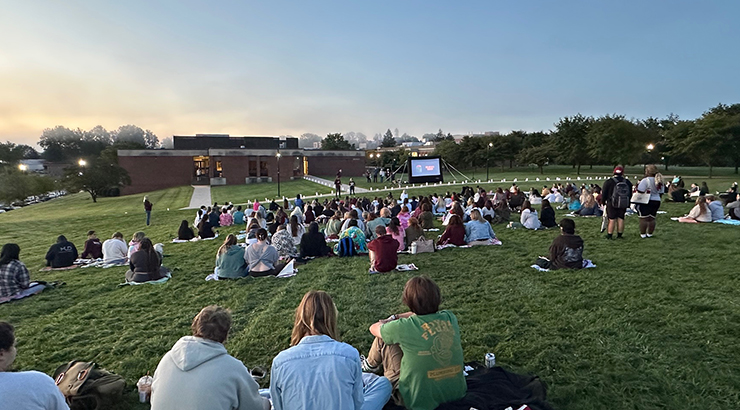 senior students sitting on grass