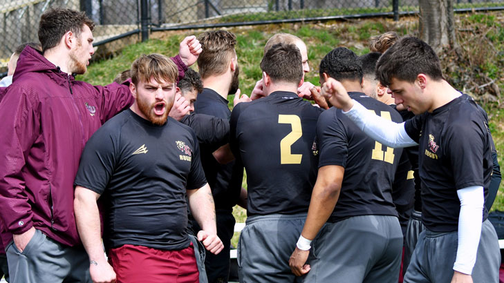 Photo of mens rugby huddle at Maryland 7s