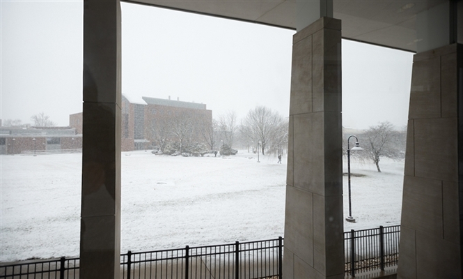 View of north campus snow covered grass and trees