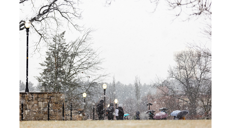 Students walking along alumni plaza in the snow