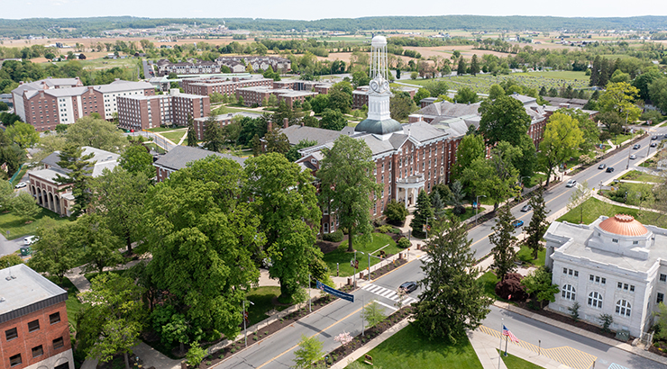 An aerial image of campus featuring old main tower and main street of Kutztown