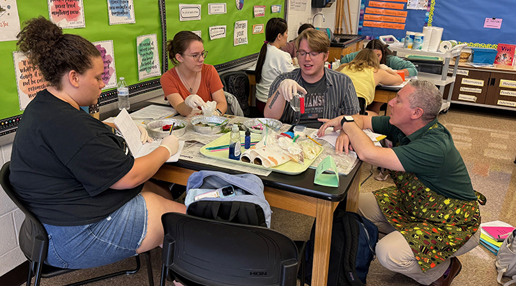 Faculty and students at a classroom table