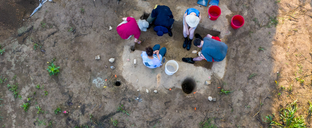 Students working at the dig site, viewed from above.
