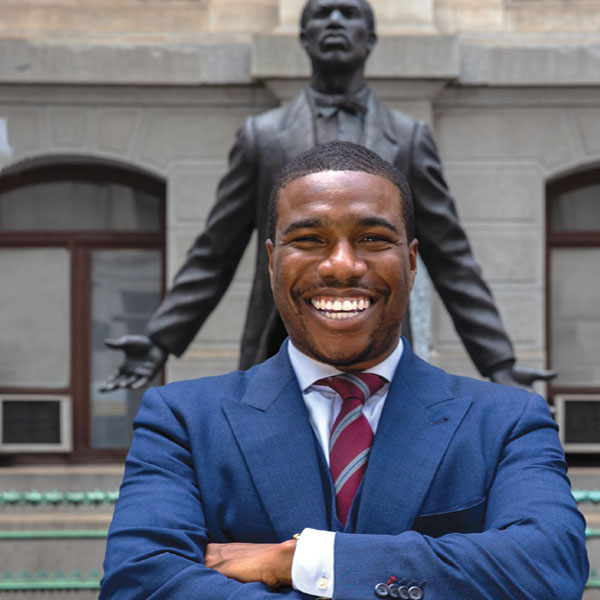 Kevin Harden Jr. stands in front of the Octavius V. catto statue at City Hall in Philadelphia