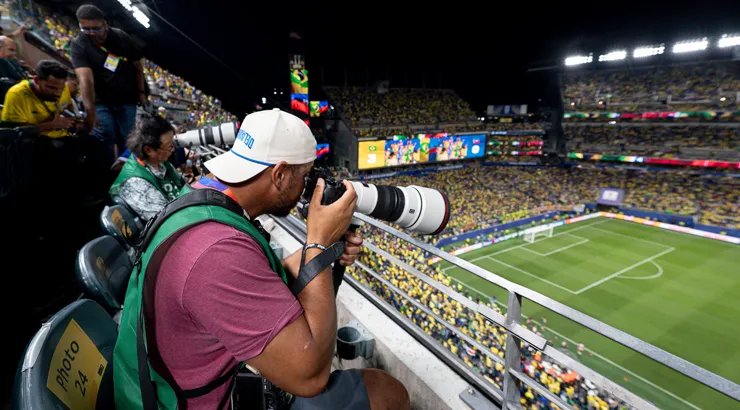 Michael Reeves holding camera equipment at a FIFA stadium.