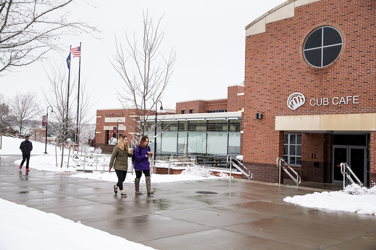 Students walking in front of the Cub Cafe main entrance in the MSU