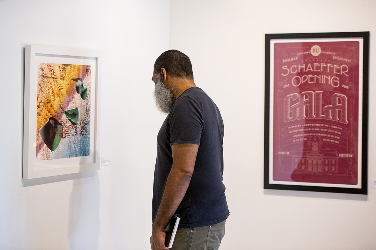 Student looking at a painting, with a poster advertising the Schaeffer Opening gala in the background 