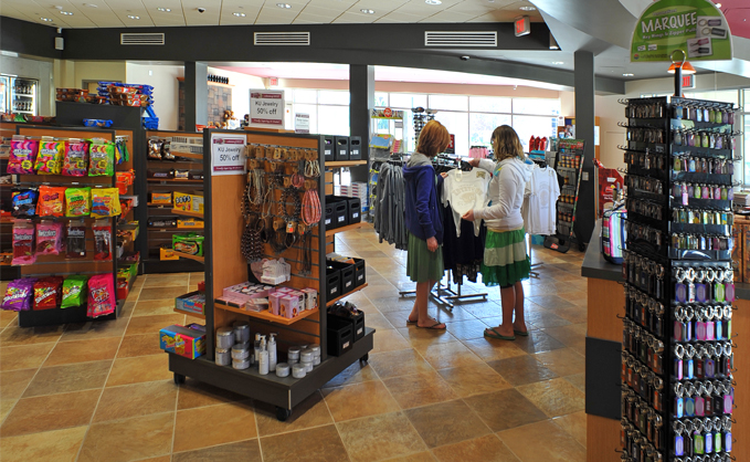 Interior of Dixon marketplace with two female students looking at a clothing display 