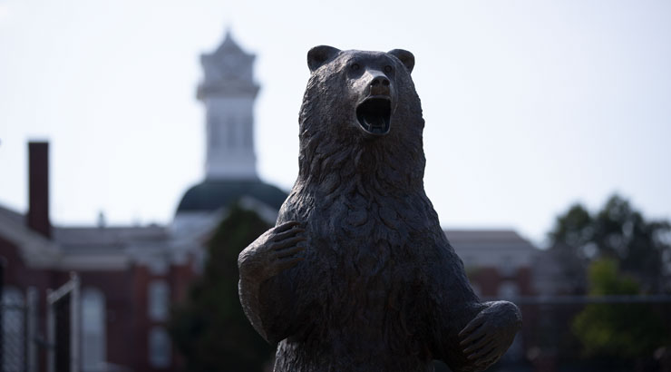 Bear statue in foreground, Old Main Clock Tower in background