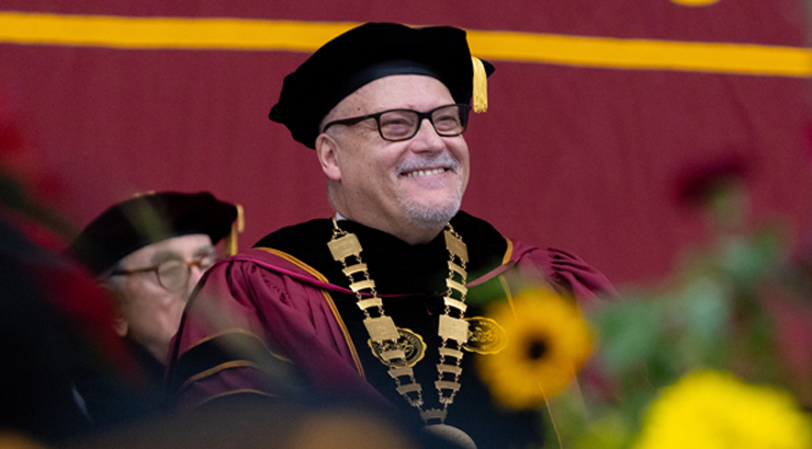 President Cavalier wearing commencement regalia