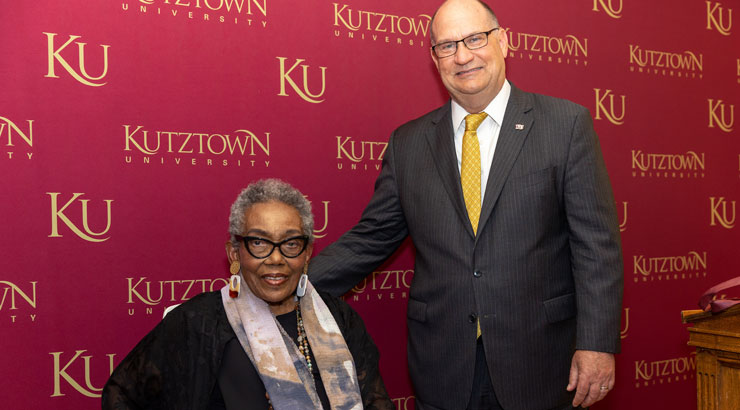 Bessie Reese Crenshaw, left, receives president's medal from President Hawkinson, right.