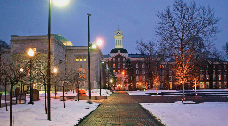 Old Main at night with snow on ground.