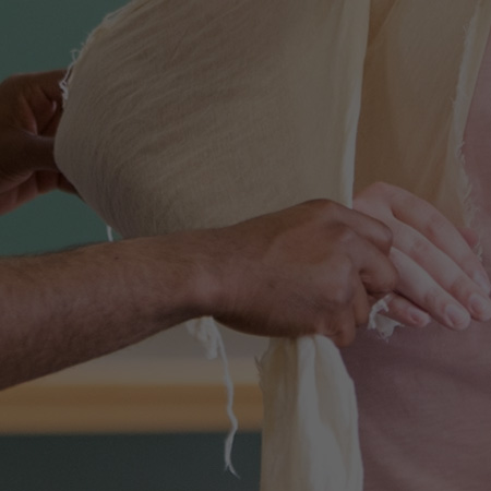 hands arranging a bandage on an arm