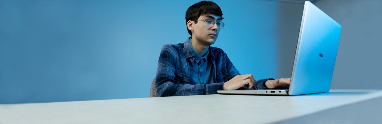 A male student working on a laptop computer