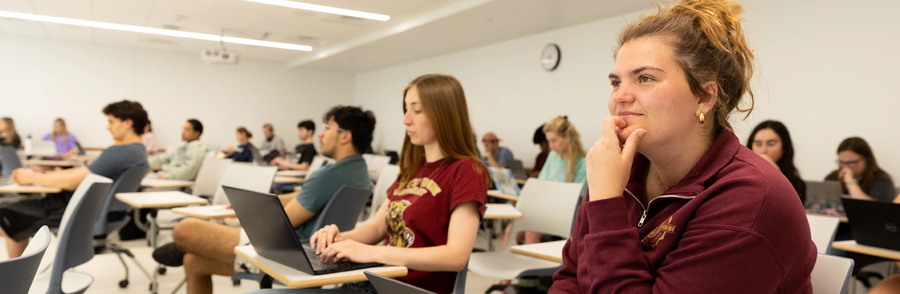 students sitting at desks in a kutztown university classroom with attentions toward the teachings being given