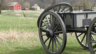 Picture of a hand holding a dated coin, the type of artifacts you will discover as a history major at Kutztown University.