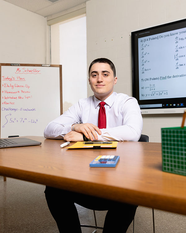 Secondary education student sitting at a desk in a classroom