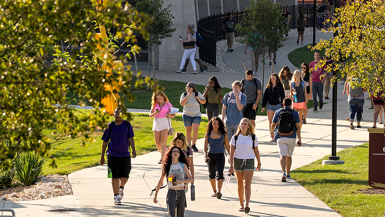students walking on the path going to and from classes