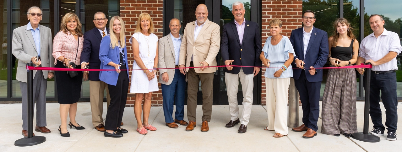 Dignitaries assembled to cut the ribbon officially re-opening Johnson Hall