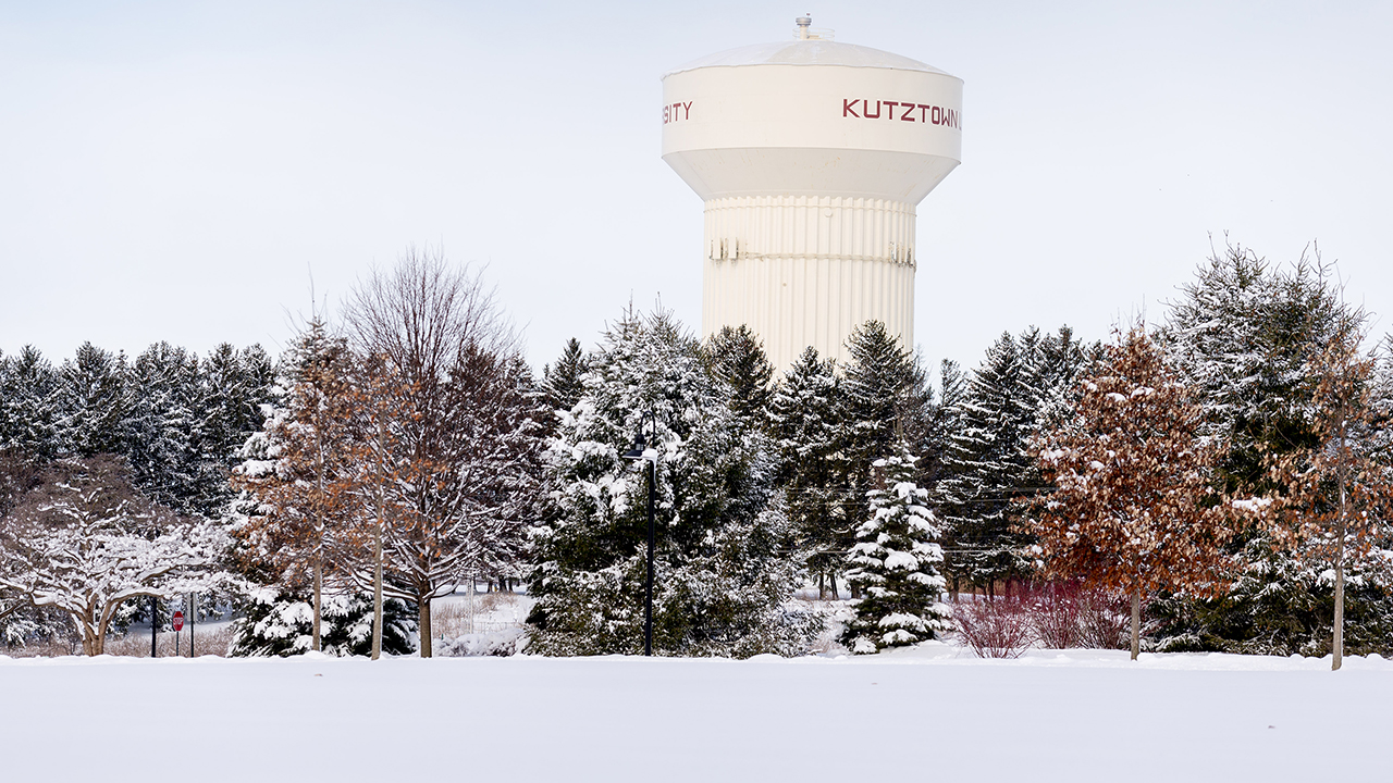Water tower and trees in snow.