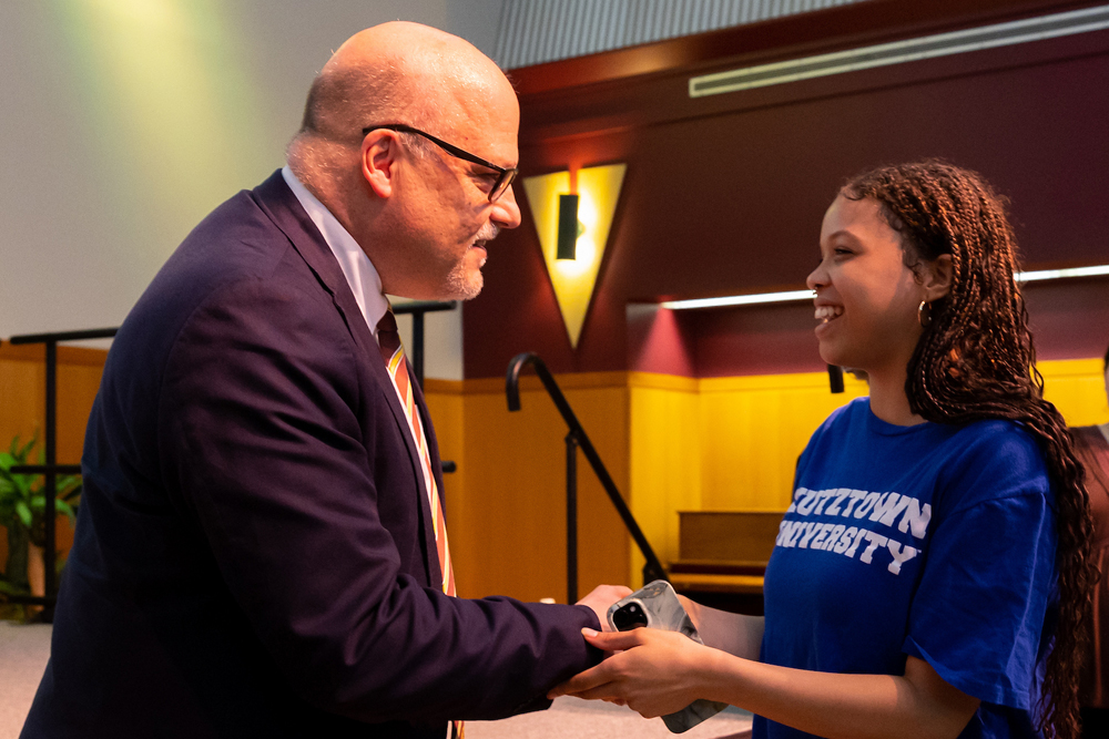 President Cavalier greets a student at his introductory gathering.