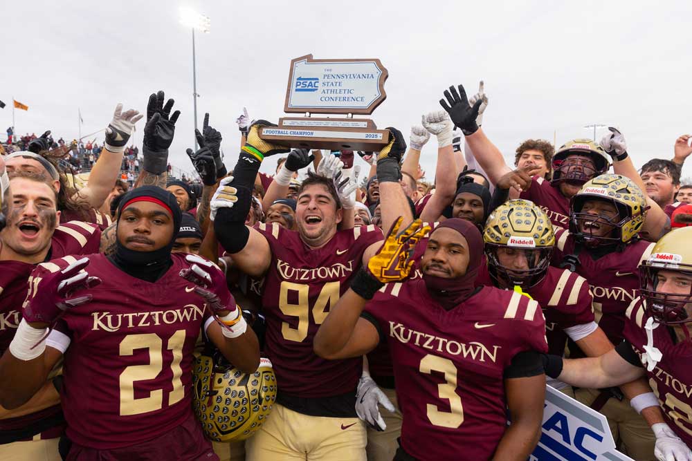 Football players celebrate winning PSAC Championship